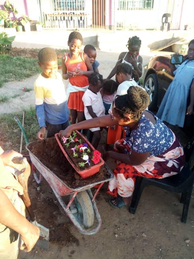 Jeannie planting flowers