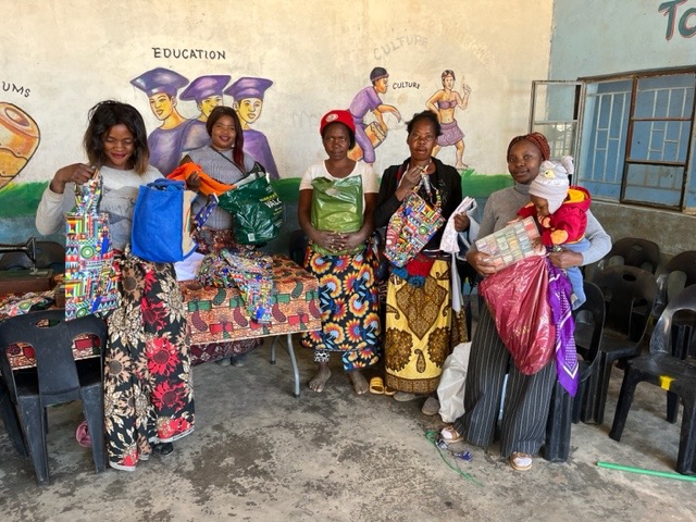 Womens sewing group showing off reuasable shopping bags they have made to sell at local markets